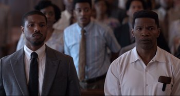 Movie still from “Just Mercy” (2019), directed by Destin Daniel Cretton – A group of people standing in a room; Medium shot, High angle