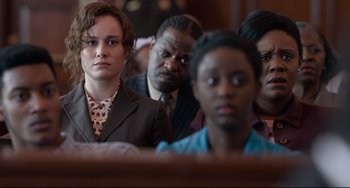 Movie still from “Just Mercy” (2019), directed by Destin Daniel Cretton – A group of people sitting in front of each other in a church; Close Up shot, Over the shoulder angle