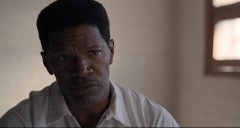 Movie still from “Just Mercy” (2019), directed by Destin Daniel Cretton – A person wearing a white dress shirt; Close Up shot, Over the shoulder angle
