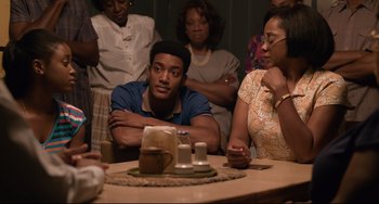 Movie still from “Just Mercy” (2019), directed by Destin Daniel Cretton – A group of people sitting around a table; Medium shot, Over the shoulder angle