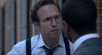Movie still from “Just Mercy” (2019), directed by Destin Daniel Cretton – A man wearing glasses talking to another man wearing a tie; Close Up shot, Over the shoulder angle