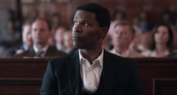Movie still from “Just Mercy” (2019), directed by Destin Daniel Cretton – A man in a suit and tie in a courtroom; Close Up shot, Over the shoulder angle