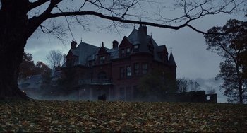 Movie still from “Knives Out” (2019), directed by Rian Johnson – A large red brick house with a large tree in front of it; Extreme Wide shot, Low angle
