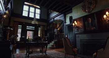 Movie still from “Knives Out” (2019), directed by Rian Johnson – A living room filled with furniture next to a fireplace; Extreme Wide shot, Low angle
