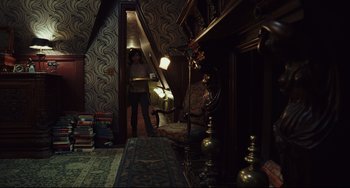 Movie still from “Knives Out” (2019), directed by Rian Johnson – A person standing in a room with a lamp; Wide shot, High angle