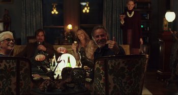 Movie still from “Knives Out” (2019), directed by Rian Johnson – A group of people sitting at a table with wine glasses; Wide shot, High angle