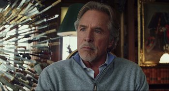 Movie still from “Knives Out” (2019), directed by Rian Johnson – An older man with long gray hair wearing a gray sweater; Close Up shot, Over the shoulder angle
