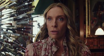 Movie still from “Knives Out” (2019), directed by Rian Johnson – A person with long blonde hair; Close Up shot, Over the shoulder angle