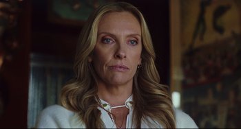 Movie still from “Knives Out” (2019), directed by Rian Johnson – A person with long hair; Close Up shot, Low angle