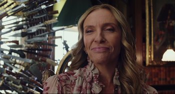 Movie still from “Knives Out” (2019), directed by Rian Johnson – A person with long hair wearing a dress; Close Up shot, Over the shoulder angle