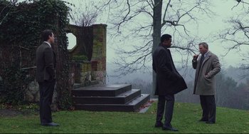Movie still from “Knives Out” (2019), directed by Rian Johnson – A man standing in front of a tree in the fog; Wide shot, Over the shoulder angle
