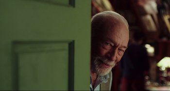 Movie still from “Knives Out” (2019), directed by Rian Johnson – An older man standing in front of a green door; Close Up shot, Over the shoulder angle