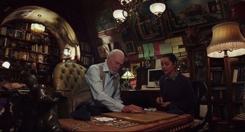 Movie still from “Knives Out” (2019), directed by Rian Johnson – A man and a woman are playing a game of cards; Medium shot, Over the shoulder angle