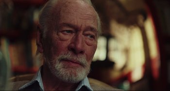 Movie still from “Knives Out” (2019), directed by Rian Johnson – An old man with a beard is looking at the camera; Close Up shot, Over the shoulder angle