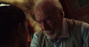 Movie still from “Knives Out” (2019), directed by Rian Johnson – An old man with a beard and mustache looking at the camera; Close Up shot, Over the shoulder angle