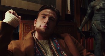 Movie still from “Knives Out” (2019), directed by Rian Johnson – A person sitting in a chair; Close Up shot, Low angle