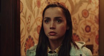 Movie still from “Knives Out” (2019), directed by Rian Johnson – A person with long black hair; Close Up shot, Low angle