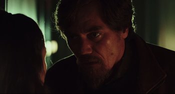 Movie still from “Knives Out” (2019), directed by Rian Johnson – A person with long hair and a goatee; Close Up shot, Over the shoulder angle