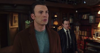 Movie still from “Knives Out” (2019), directed by Rian Johnson – A man in a brown jacket and a man in a black suit; Medium shot, Low angle