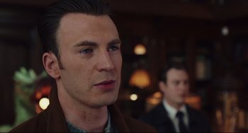 Movie still from “Knives Out” (2019), directed by Rian Johnson – A person wearing a suit and tie; Close Up shot, Over the shoulder angle