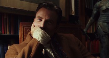 Movie still from “Knives Out” (2019), directed by Rian Johnson – A man in a brown jacket and a white scarf; Close Up shot, Over the shoulder angle