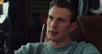 Movie still from “Knives Out” (2019), directed by Rian Johnson – A person sitting in a chair wearing a sweater; Close Up shot, Over the shoulder angle