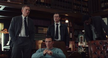 Movie still from “Knives Out” (2019), directed by Rian Johnson – A group of men standing next to each other in a room; Medium shot, Low angle