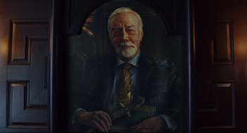 Movie still from “Knives Out” (2019), directed by Rian Johnson – A painting of an older man in a suit and tie; Close Up shot, Low angle