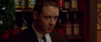 Movie still from “L.A. Confidential” (1997), directed by Curtis Hanson – A person wearing a suit and tie; Close Up shot, Low angle