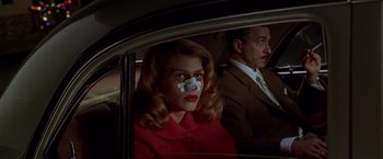 Movie still from “L.A. Confidential” (1997), directed by Curtis Hanson – A man and a woman in the back seat of a car; Close Up shot, Low angle