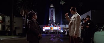 Movie still from “L.A. Confidential” (1997), directed by Curtis Hanson – A couple of men standing next to each other on a street; Extreme Wide shot, Low angle
