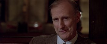 Movie still from “L.A. Confidential” (1997), directed by Curtis Hanson – An older man wearing a suit and a tie; Close Up shot, Low angle