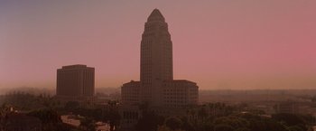 Movie still from “L.A. Confidential” (1997), directed by Curtis Hanson – A view of a large building in the middle of a city; Extreme Wide shot, High angle