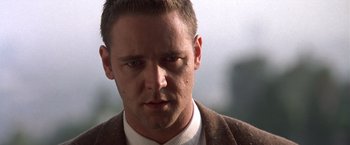 Movie still from “L.A. Confidential” (1997), directed by Curtis Hanson – A person wearing a suit and tie; Close Up shot, Low angle