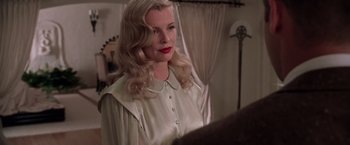 Movie still from “L.A. Confidential” (1997), directed by Curtis Hanson – A woman with blonde hair wearing a white shirt; Close Up shot, Over the shoulder angle