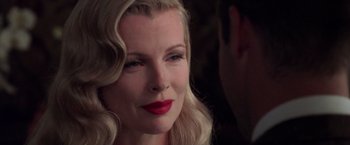 Movie still from “L.A. Confidential” (1997), directed by Curtis Hanson – A person with blonde hair and red lipstick; Close Up shot, Over the shoulder angle