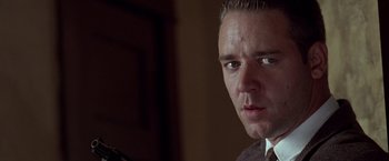 Movie still from “L.A. Confidential” (1997), directed by Curtis Hanson – A person wearing a suit and tie; Close Up shot, Low angle