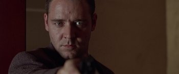 Movie still from “L.A. Confidential” (1997), directed by Curtis Hanson – A person holding a gun; Close Up shot, Low angle