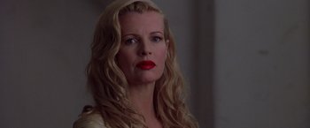 Movie still from “L.A. Confidential” (1997), directed by Curtis Hanson – A woman with blonde hair and red lipstick looking to her left; Close Up shot, Over the shoulder angle