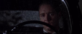 Movie still from “L.A. Confidential” (1997), directed by Curtis Hanson – A person driving a car in the dark; Close Up shot, Low angle