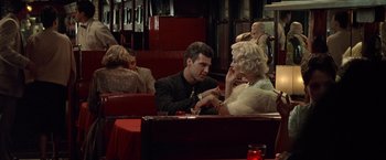 Movie still from “L.A. Confidential” (1997), directed by Curtis Hanson – A man and a woman sitting at a table in a restaurant; Medium shot, Over the shoulder angle