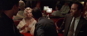 Movie still from “L.A. Confidential” (1997), directed by Curtis Hanson – A man and a woman sitting at a table in front of each other; Medium shot, Over the shoulder angle