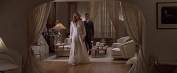 Movie still from “L.A. Confidential” (1997), directed by Curtis Hanson – A man and a woman standing in a living room next to each other; Wide shot, Low angle