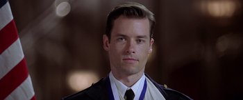 Movie still from “L.A. Confidential” (1997), directed by Curtis Hanson – A person wearing a suit and tie; Close Up shot, Low angle