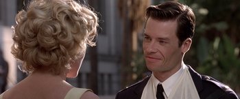 Movie still from “L.A. Confidential” (1997), directed by Curtis Hanson – A man and a woman talking to each other; Close Up shot, Over the shoulder angle