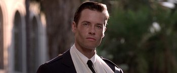 Movie still from “L.A. Confidential” (1997), directed by Curtis Hanson – A person wearing a suit and tie; Close Up shot, Low angle