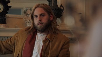 Movie still from “Don't Worry, He Won't Get Far on Foot” (2018), directed by Gus Van Sant – A man with long hair and a long beard; Medium shot, Over the shoulder angle