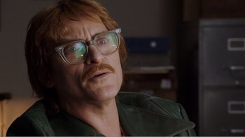 Movie still from “Don't Worry, He Won't Get Far on Foot” (2018), directed by Gus Van Sant – A person wearing glasses and a green jacket; Close Up shot, Low angle