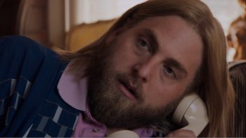 Movie still from “Don't Worry, He Won't Get Far on Foot” (2018), directed by Gus Van Sant – A man with long hair and a goatee talking on a phone; Close Up shot, Overhead angle