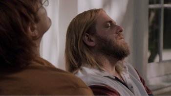 Movie still from “Don't Worry, He Won't Get Far on Foot” (2018), directed by Gus Van Sant – A man with long hair and a long beard; Close Up shot, High angle